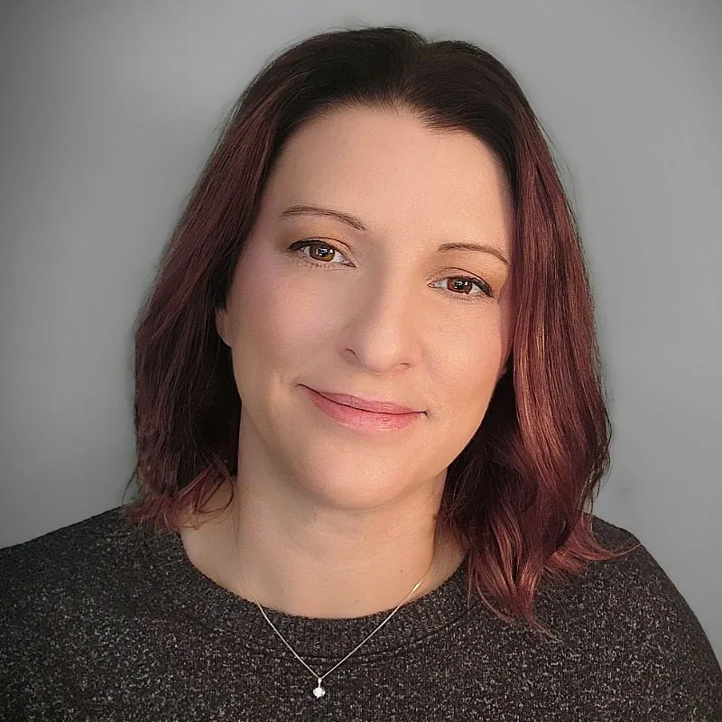 Female with shoulder length mahogany colored hair