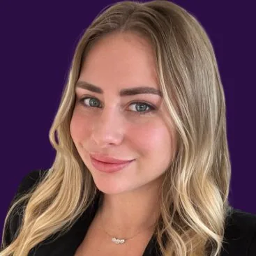 Female with blonde hair posing for headshot, purple background