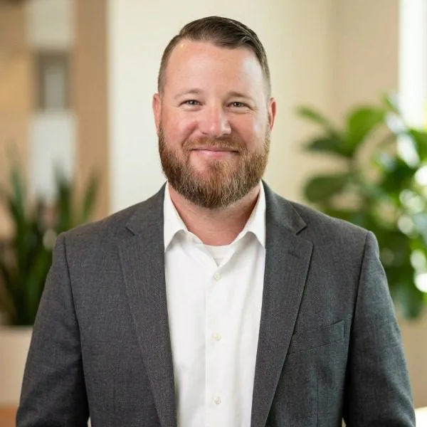 Zachary Willis - man wearing white button up shirt and gray suit jacket