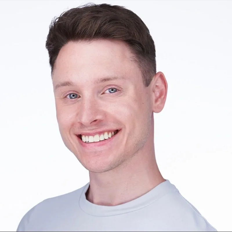 male with combed back short brown hair wearing a white tshirt