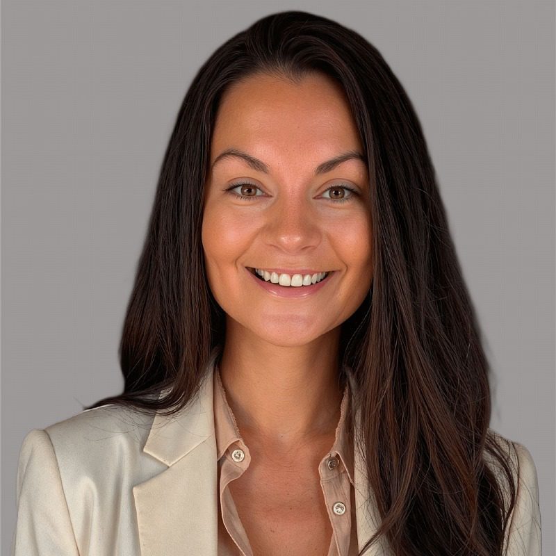 Female with long dark brown hair wearing a button up shirt and blazer